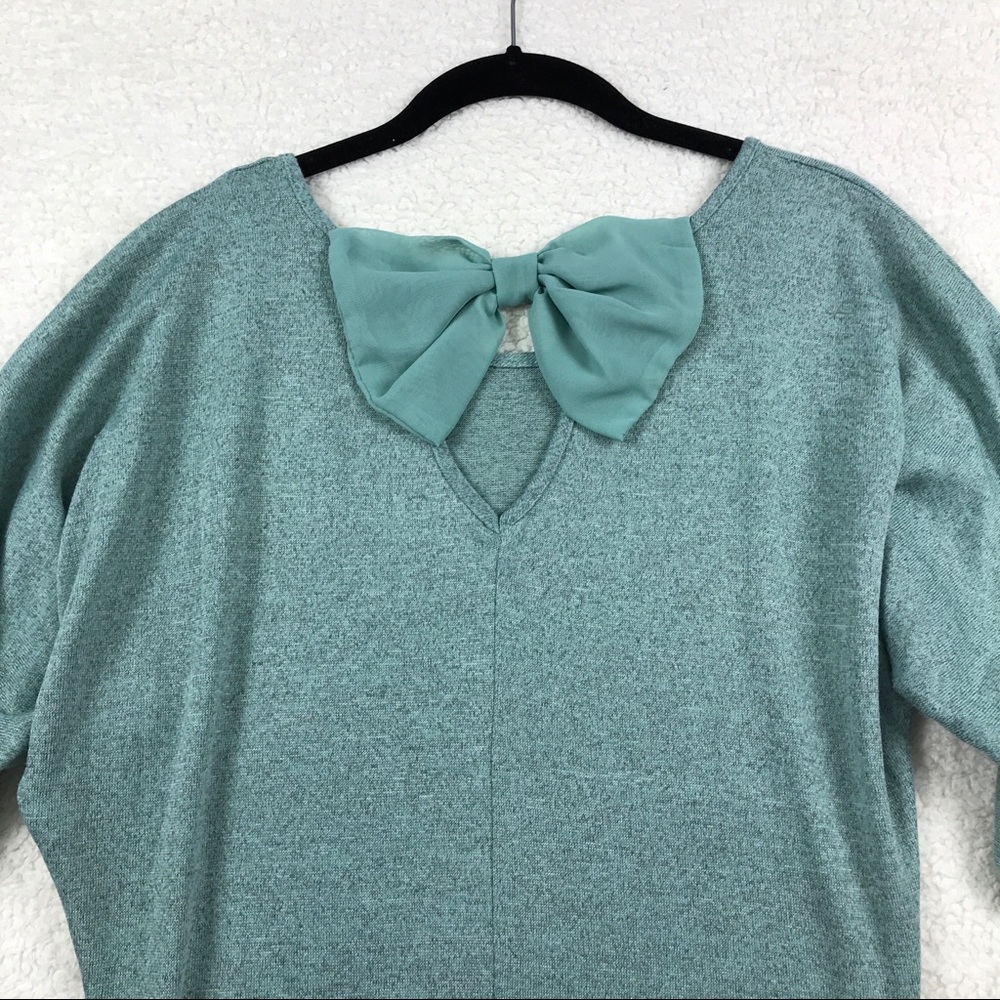 Tempted teal shirt with bow on back